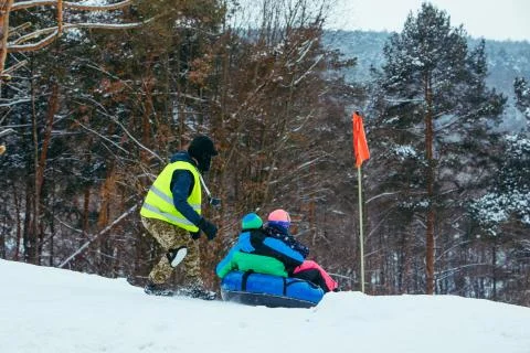 Winter fun activities. ride down by hill on snow tubing Stock Photos
