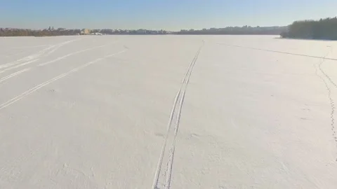 Winter fun. A trip on a snowmobile over frozen lake ice Stock Footage 86283644