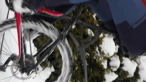 In winter, a guy rides a bicycle through deep snow among snow covered trees Stock Footage 263578362
