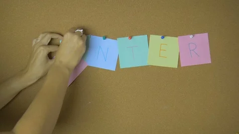 Winter. Hands pining and taking off sticky windy notes on pin board funny Stock Footage 99563208