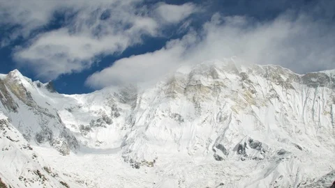 Winter high altitude mountains with cloudy blue sky background Stock Footage 121575494