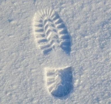 Winter high boot footprint on the first snow Stock Photos