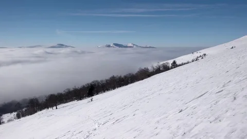 Winter Hike Above the Clouds With a View of the Distant Peaks by a Coast of the Stock Footage 71200783