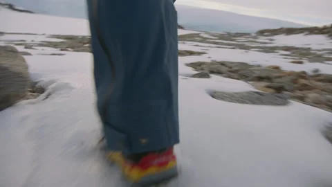 Winter hiking adventure with a man navigating snowy terrain in a beautiful Stock Footage 288193451