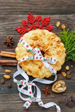Winter holiday rustic background with peanuts tart and cinnamon. Christmas an Stock Photos