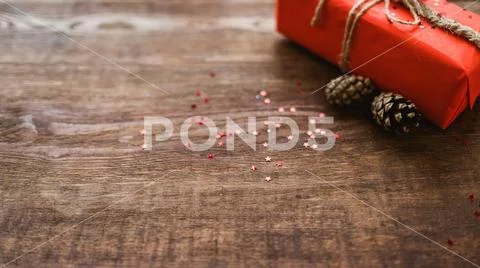 Winter holiday surprise red gift box pine cones Stock Photos