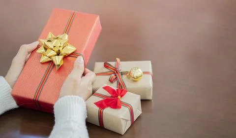 Winter holidays concept - back view of senior woman with christmas gifts on.. Stock Photos