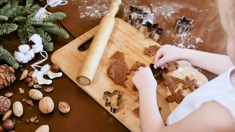 Winter holidays concept. Slow motion. Little girl sculpts gingerbread on the Stock Footage 145177016