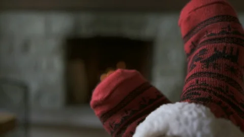 Winter holidays : relaxing time with red warm socks in front of the fire Stock Footage 104900247