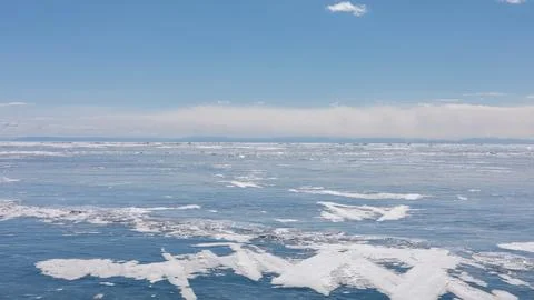 Winter ice and snow patterns on Lake Baikal under clear blue sky panorama Stock Photos