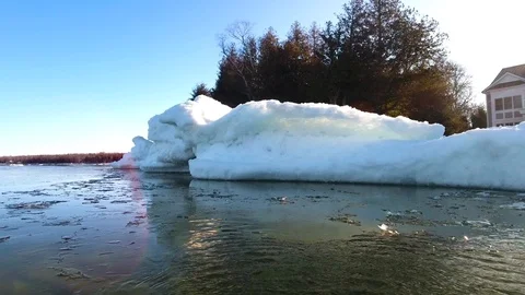 Winter ice and snow piles along shoreline. Stock Footage 124875575