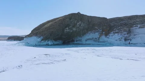 Winter ice cliffs and frozen Lake Baikal shoreline at Cape Kharantsy, Russia Stock Footage 334101917