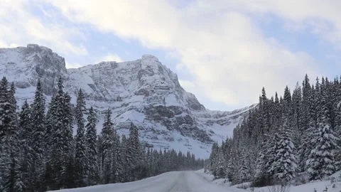 Winter Ice Driving Through Snow Mountains And Pine Trees In Banff Canada Stock Footage 132958359