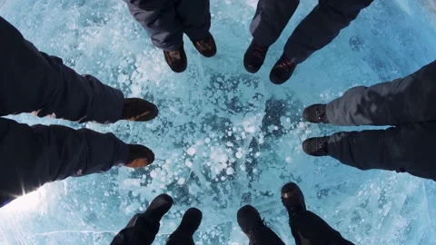 Winter ice Lake Baikal bubbles, friendly team people tourists in circle. Travel  Stock Footage 165216716