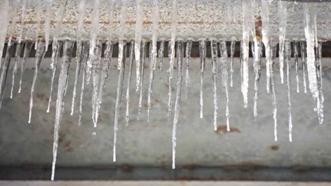 Winter icicles cold ice cones freeze melt dripping water_slow motion Stock Footage 261795825