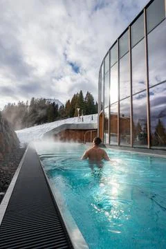 Winter infinity pool at glass spa in Oberlech, Austria, Arlberg Stock Photos