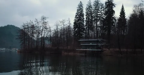 Winter Lakeside Café – Pan from Right to Left Over Snowy Shoreline Stock Footage 300994081