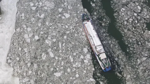 Winter landscape from a height. Barge on the river among the ice floes Stock Footage 117173674