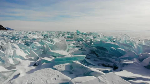 Winter landscape. Hummocks, blocks of blue transparent ice near the shore Stock Footage 200434939