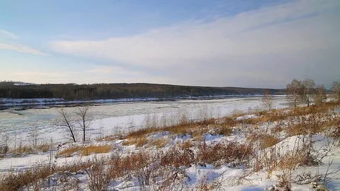 Winter landscape ice drift on the river snow drifts evening light at sunset Stock Footage 95805831