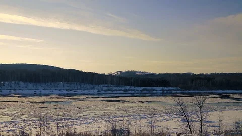 Winter landscape ice drift on the river snow drifts evening light at sunset Stock Footage 95805857