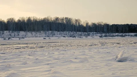 Winter landscape ice drift on the river snow drifts evening light at sunset Stock Footage 95805921
