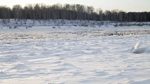 Winter landscape ice drift on the river snow drifts evening light at sunset Stock Footage 95805996