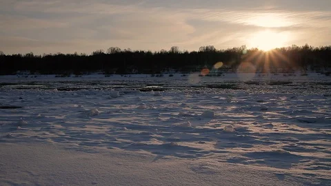 Winter landscape ice drift on the river snow drifts evening light at sunset Stock Footage 95806002