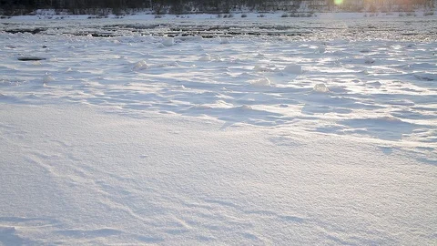 Winter landscape ice drift on the river snow drifts evening light at sunset Stock Footage 95806003