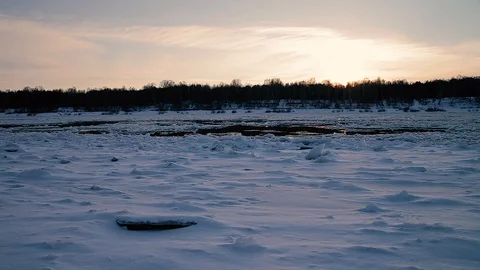 Winter landscape ice drift on the river snow drifts evening light at sunset Stock Footage 95806005