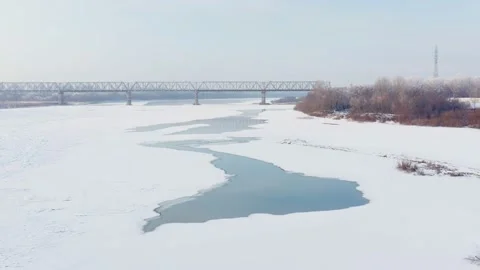 Winter landscape: ice is forming on the river and bridge in the background Stock Footage 144941827