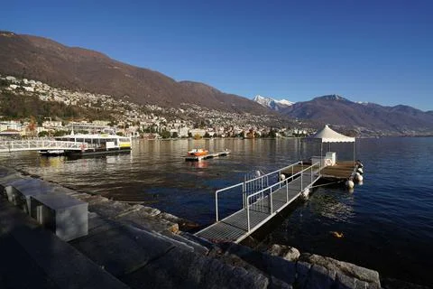 Winter landscape of lake Maggiore with boats in Locarno, Switzerland Stock Photos