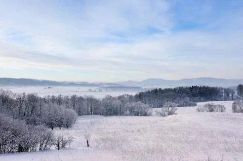 Winter landscape with mountains in background. Stock Photos