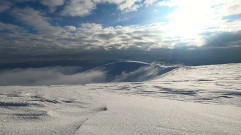 Winter landscape in the mountains. Clouds run to the mountains. Sunny day in the Stock Footage 178539623