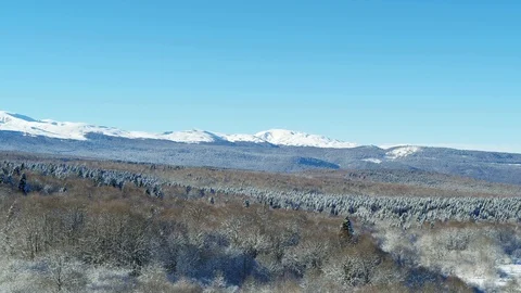 Winter landscape: mountains covered with forest. Aerial shoot Stock Footage 116786777