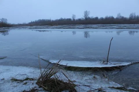 Winter landscape overlooking the river in cold tones Stock Photos