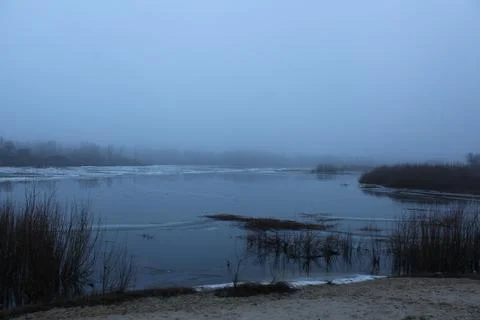 Winter landscape overlooking the river in cold tones Stock Photos