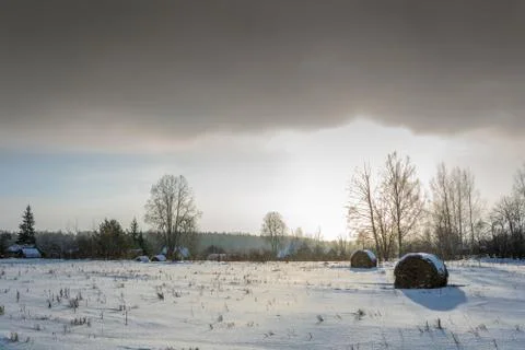 Winter landscape in the rays of the setting sun. Stock Photos