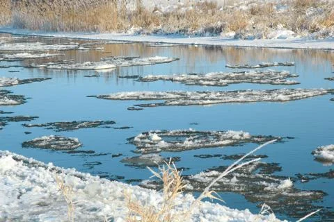 Winter landscape. Reflection of blue sky in a river. Stock Photos