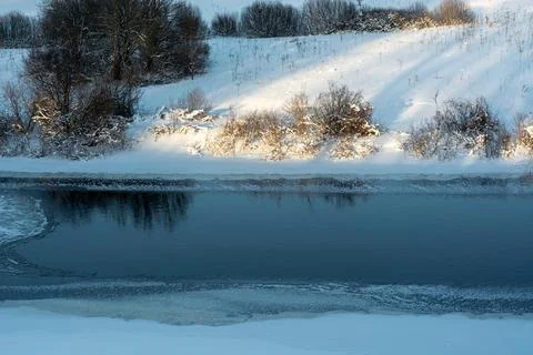 Winter landscape with a river. Stock Photos