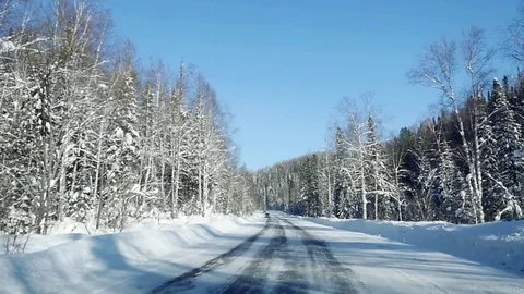 Winter landscape with road at forest and the blue sky in slowmotion. 1920x1080 Video stock 70356954