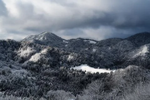 Winter landscape scene with dramatic clouds just before storm Stock Photos