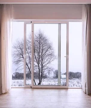 Winter Landscape Seen Through Large Glass Doors Foto stock