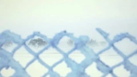 Winter landscape as seen through the wire fence. 4K video. Seamless loop. Stock Footage 341266226