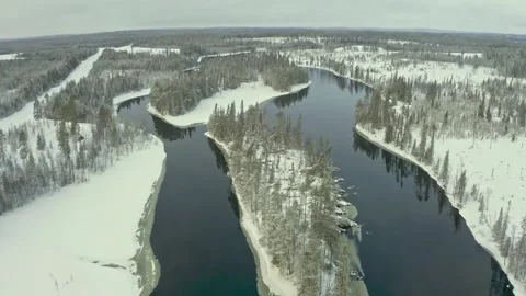 Winter landscape showcasing a snowy river and island in a serene, untouched wild Stock Footage 289464373