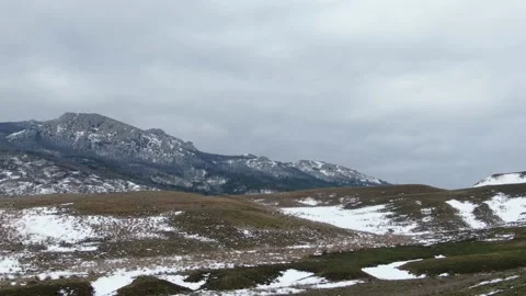 Winter landscape slopes of snow capped mountains against the backdrop of a cloud Stock Footage 150564252