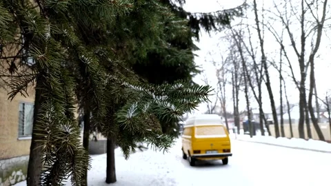 Winter landscape with spruce branches and a yellow blurred car. Video stock 170627563
