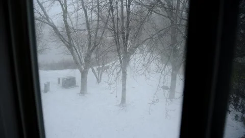 Winter landscape through the window in house. falling snow outside. Wide view Stock Footage 293856649