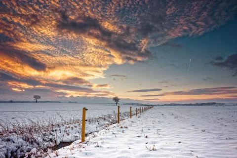 Winter landscape under the evening sunset. Stock Photos