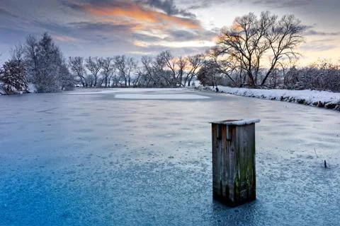 Winter landscape under the evening sunset. Stock Photos